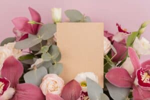 pink and white roses beside pink and white card
