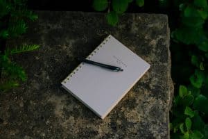 black click pen on notebook